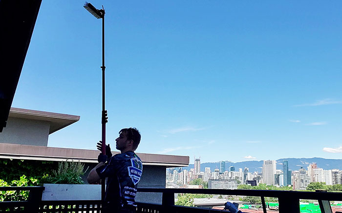 clean squad property services team member cleaning windows